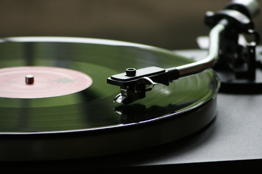 Close-up of a stylus tracking a spinning vinyl record.